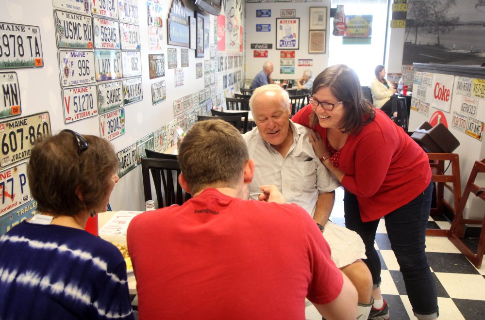 Democrat Emily Cain gives supporter David McVety, of Otisfield, a hug at Daddy O's Diner on Route 26 in Oxford while campaigning Aug. 26 in Oxford County. McVety's wife, Linda, and son Rob watch the encounter.