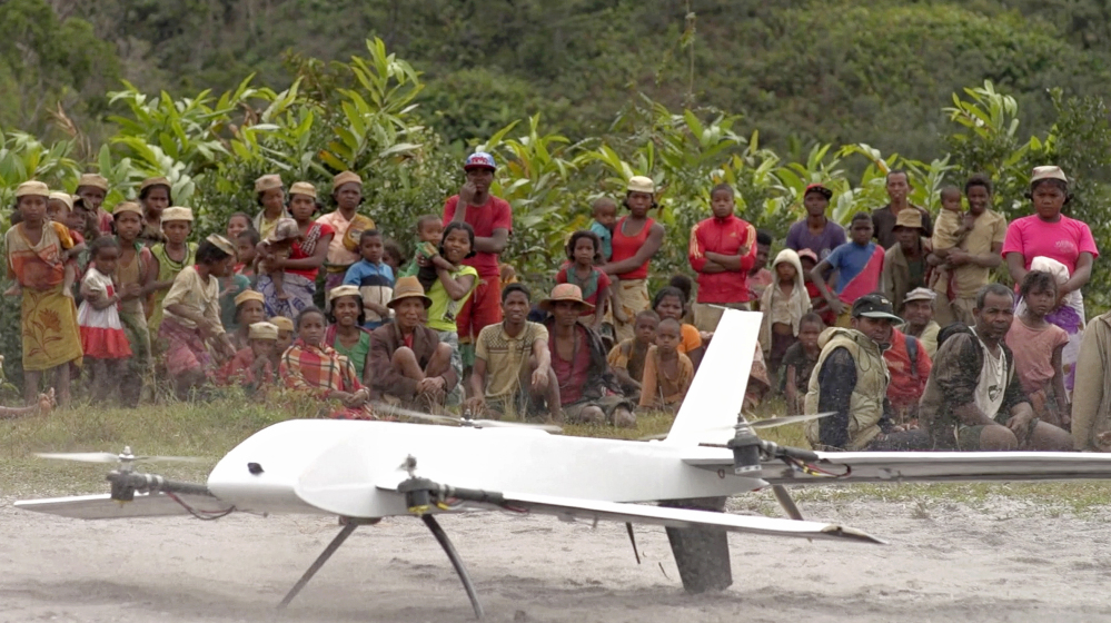 Residents of Ranomafana, Madagascar, watch before a drone containing medical samples takes off on a test flight from their remote village, which can only be reached on foot. Deliveries that would have taken weeks on land can take hours by drone.