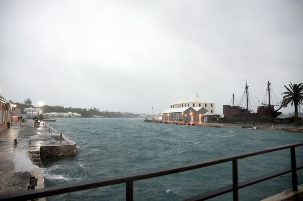 Wind brought by Hurricane Nicole makes water break over the dock on Ordnance Island in St. Georges, Bermuda, on Thursday.