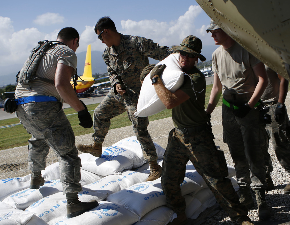 U.S. military troops load bags of rice for Hurricane Matthew relief in Port-au-Prince, Haiti, on Thursday.
