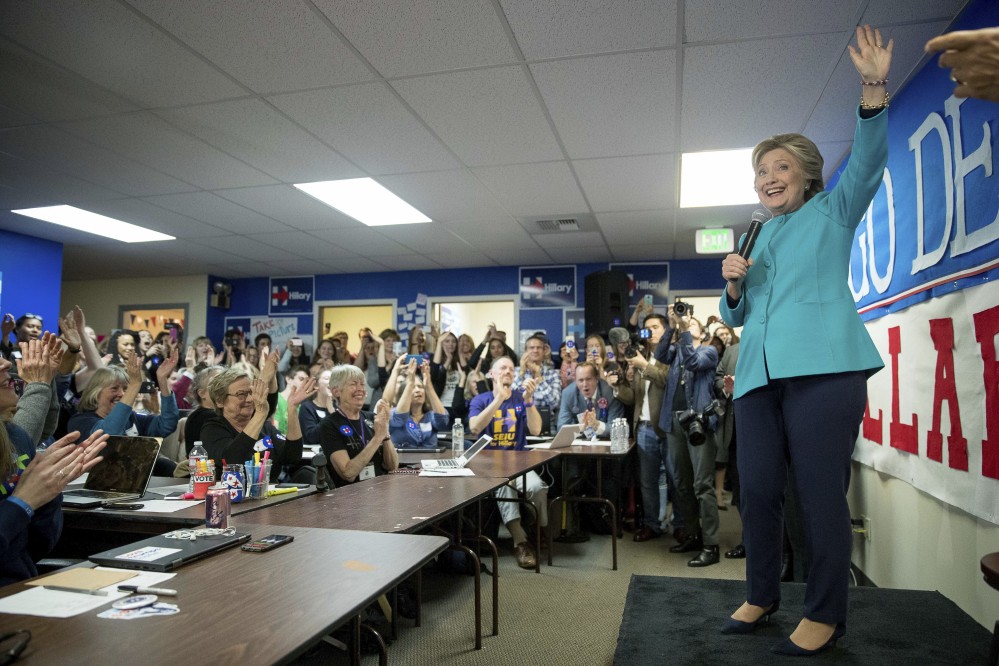 Hillary Clinton speaks to volunteers Friday at a campaign field office in Seattle. A speech transcript from 2013 in which she cited a need for "a public and a private position" has fed into suspicions that she isn't always straight with voters.