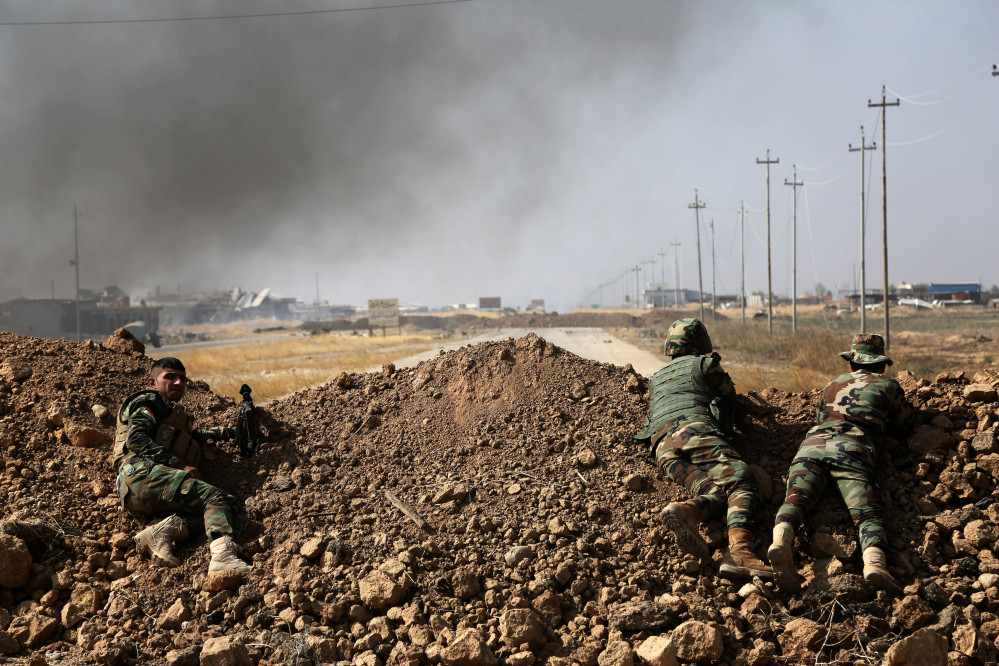 Kurdish security forces take up a position as they fight overlooking the Islamic State-controlled villages surrounding Mosul, in Khazer, about 30 kilometers (19 miles) east of Mosul, Iraq.