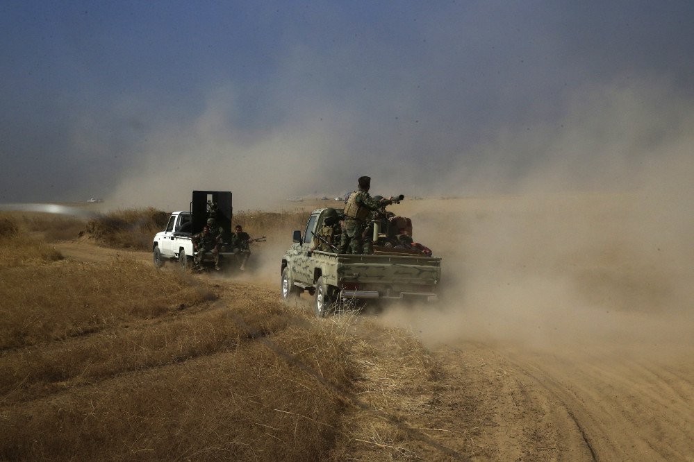 A Peshmerga convoy drives toward a frontline in Khazer, about 19 miles east of Mosul, Iraq, Monday.