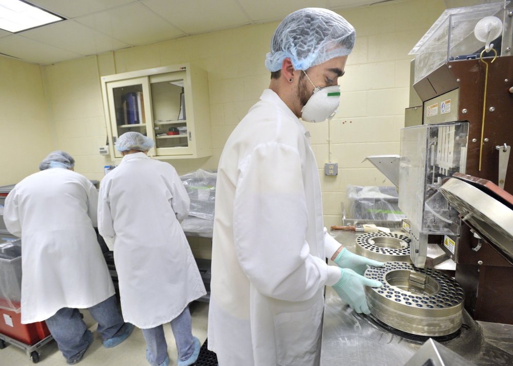 An ImmuCell production associate fills capsules with antibodies used to reduce infections in newborn dairy cattle in this 2011 photo. Maine's smallest publicly traded firm has agreed to sell 660,000 shares to raise capital from private investors for its Portland expansion.
