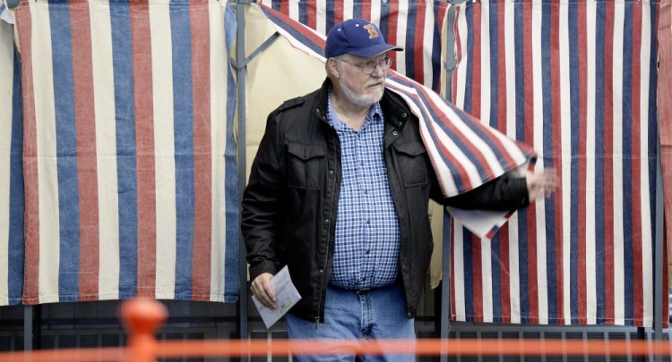 Greg Rowe of Saco leaves a booth Tuesday after voting at Saco City Hall. Mainers must provide identification when they register to vote, but do not have to show ID when casting their ballots. Gov. Paul LePage wants the state to issue voter ID cards to prevent election fraud.