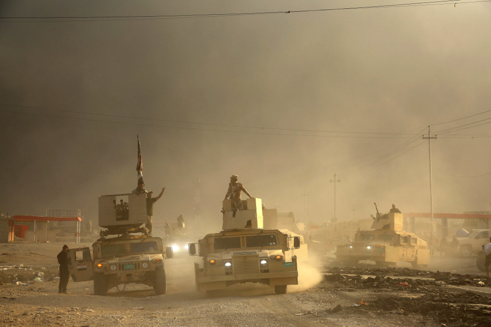 An Iraqi military convoy advances towards the city of Mosul, Iraq, on Wednesday.