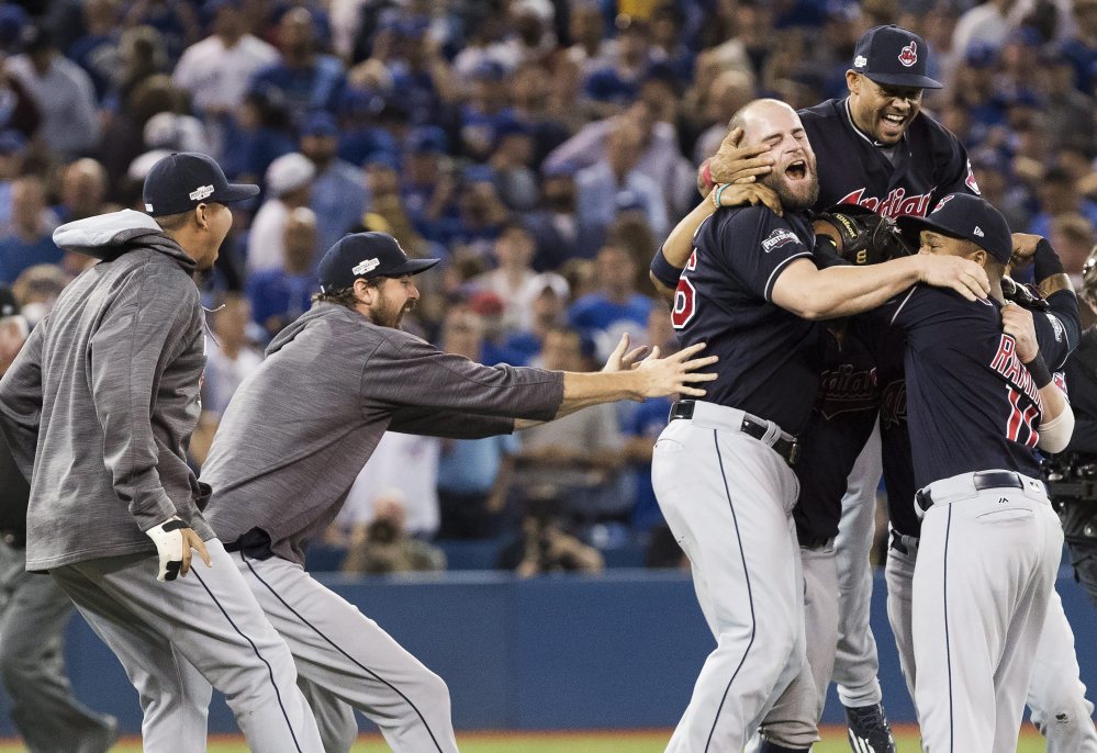 The Cleveland Indians celebrate after defeating the Toronto Blue Jays 3-0 in Game 5 of the baseball American League Championship Series in Toronto on Wednesday.