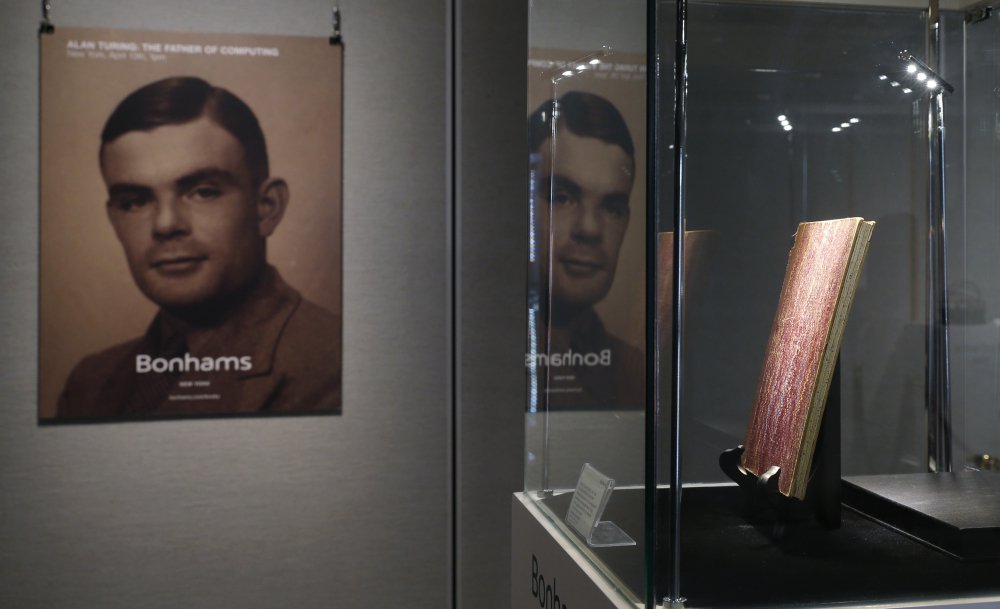 British computer science pioneer Alan Turing, whose portrait is seen at a 2015 auction preview, was a World War II code-breaking genius. After the war, he was prosecuted for having sex with a man and forced to take female hormones.
