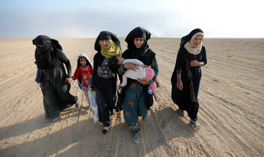 Civilians return to their village south of Mosul, Iraq, after it was liberated from Islamic State militants on Friday.
