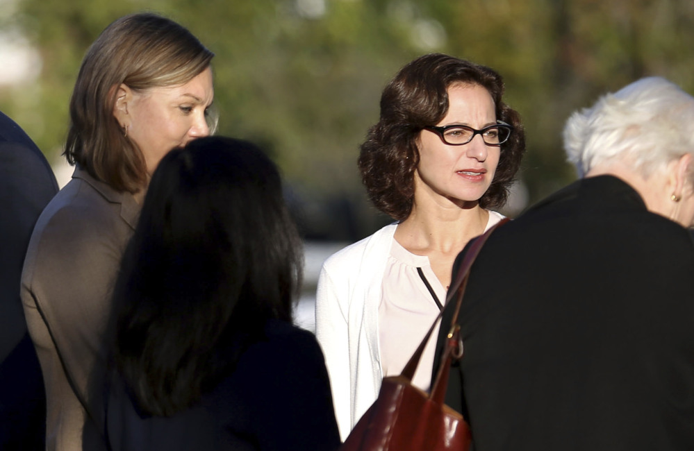 Sabrina Erdely, center, enters the federal courthouse in Charlottesville, Va., on Monday. Erdely wrote a discredited Rolling Stone article detailing an alleged rape at UVA.