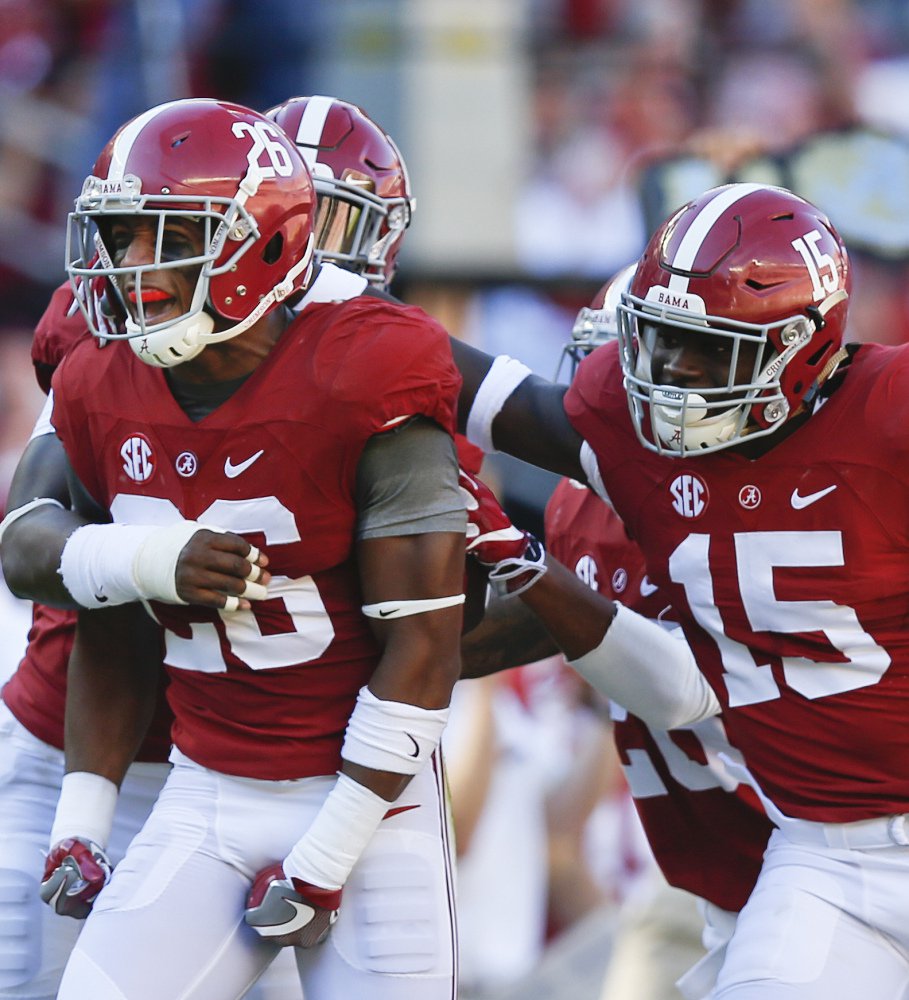 Alabama defensive back Marlon Humphrey, left, celebrates with Ronnie Harrison, right, and other teammates after an interception in the first half on Saturday during a 33-14 win over No. 6 Texas A&M.