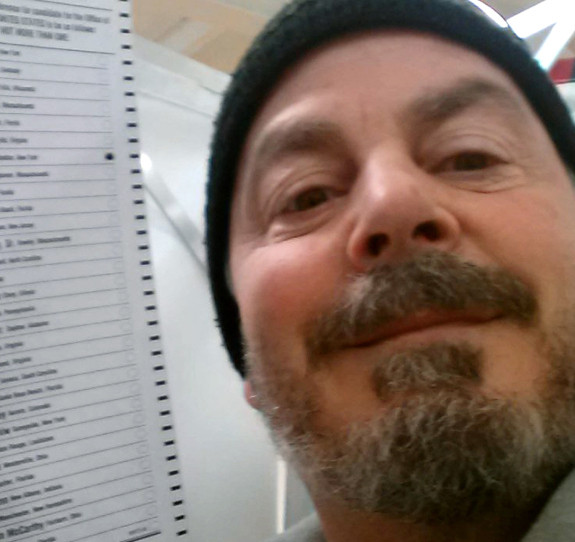 Bill Phillips of Nashua, N.H., takes a selfie with his marked ballot during the New Hampshire primary election last February.