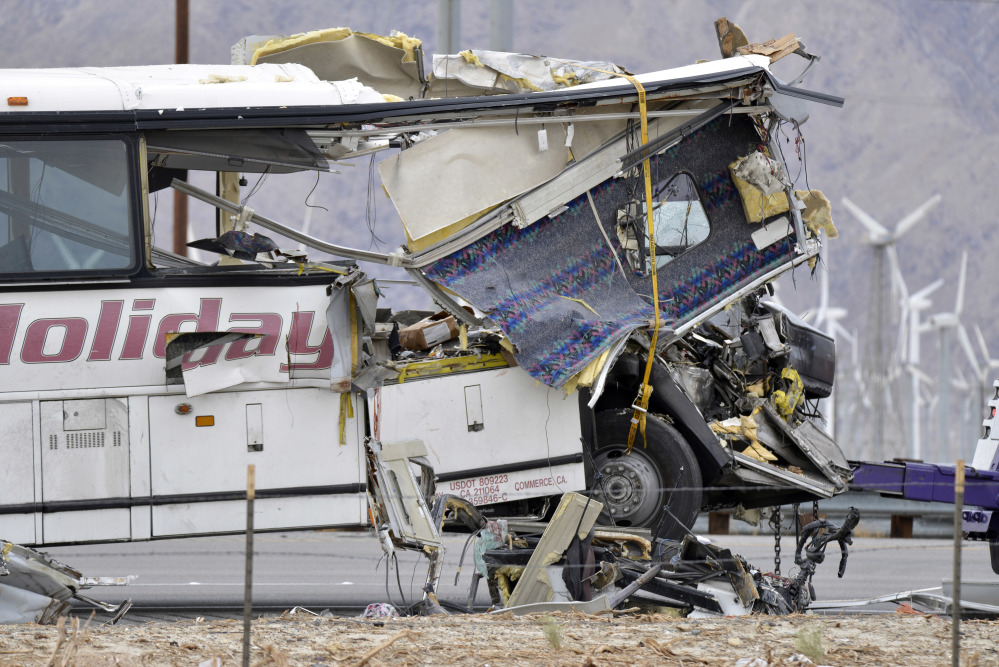 The front end of a tour bus was severely damaged when it crashed into the back of a semi-truck on Interstate 10 just north of the desert resort town of Palm Springs, in Desert Hot Springs, Calif., on Sunday.