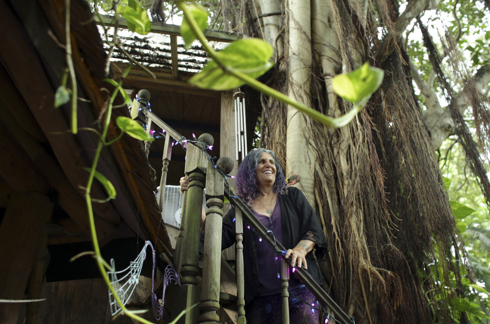 Shawnee Chasser stands on the staircase of her treehouse in Miami. She is protesting code inspectors' declaration that her home is unfit for human habitation.