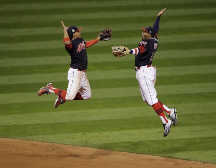 Cleveland Indians Francisco Lindor and Rajai Davis celebrate after winning Game 1 of the World Series on Tuesday night in Cleveland. The Indians won 6-0 to take a 1-0 lead in the series.