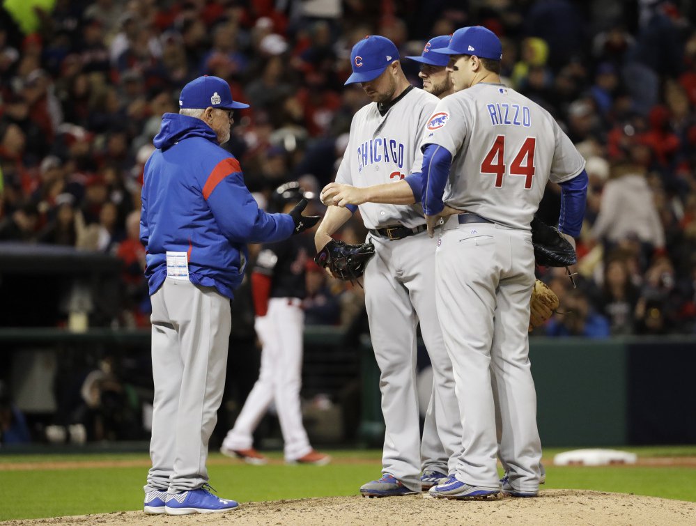 Cubs manager Joe Maddon takes starting pitcher Jon Lester out of the game in the sixth inning Tuesday night. Lester, who took the loss, came into the game with a 3-0 career record in three World Series starts, with a 0.43 ERA.
