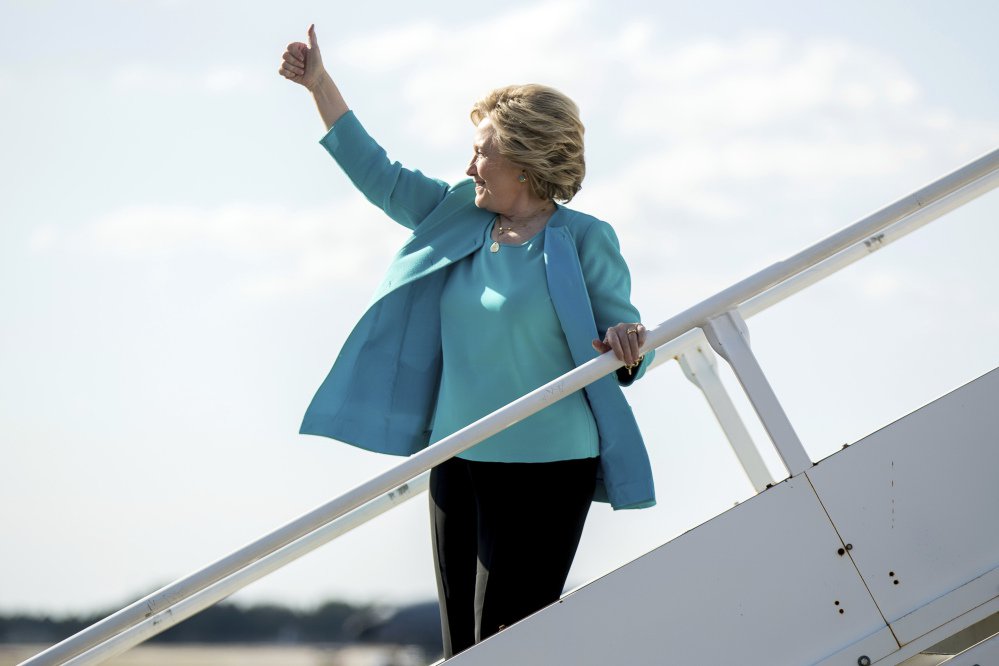 Democratic presidential candidate Hillary Clinton gives a thumbs people who cheer for her as she boards her campaign plane at Tampa International Airport in Tampa, Wednesday, Oct. 26, 2016. (AP Photo/Andrew Harnik)
