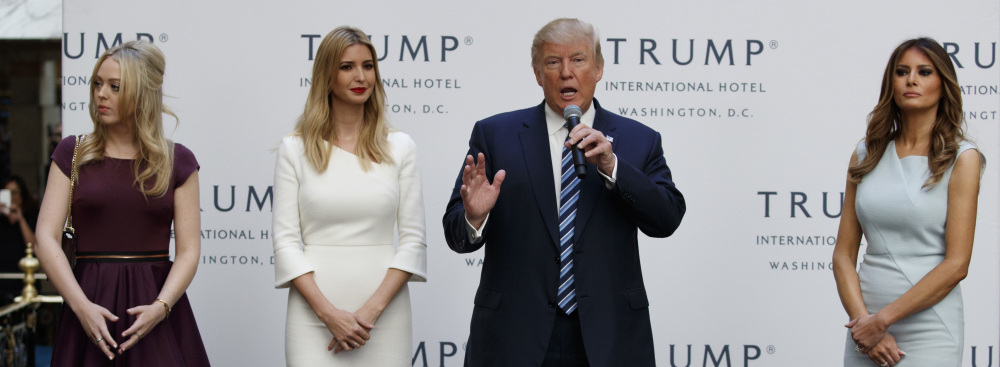 Republican presidential candidate Donald Trump, accompanied by, from left, Tiffany Trump, Ivanka Trump and Melania Trump, speaks during the grand opening of the Trump International Hotel in Washington on Wednesday.