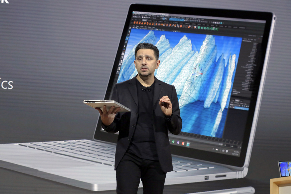 Panos Panay, Microsoft's vice president of devices, displays an updated Surface Book at a media event Wednesday in New York. "We want ... to help everyone create," he said.