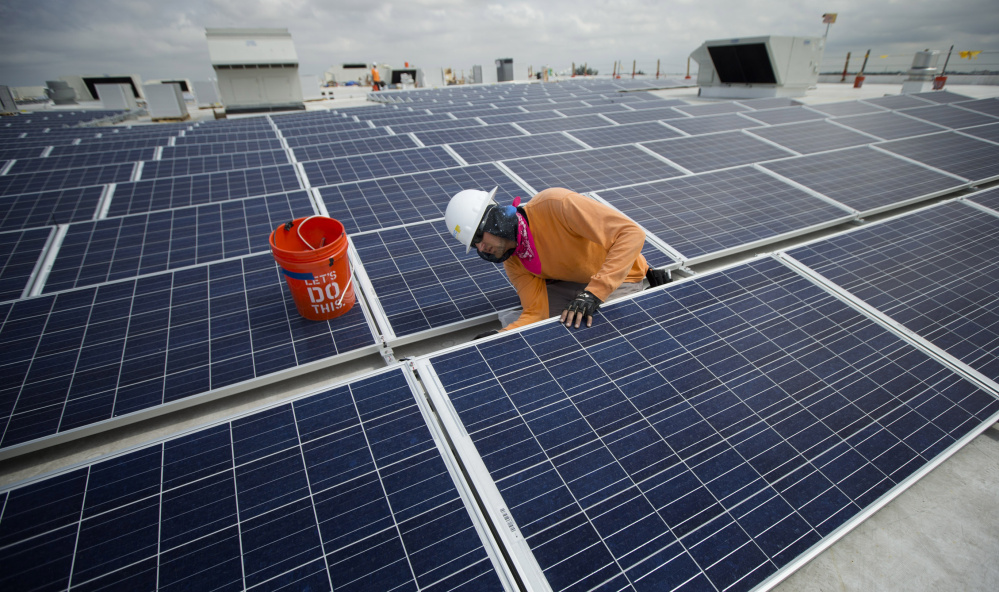 The International Energy Agency says renewable energy projects – like this 178,000-square-foot solar array being installed in Miami – surpassed all other sources of new electricity worldwide last year.