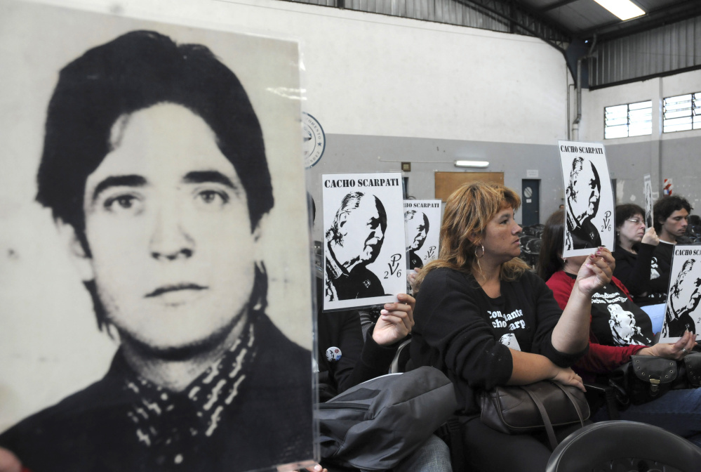 Above, activists hold portraits of missing people during the trial of Argentina's last de facto president, Gen. Reynaldo Bignone, and seven more officers accused of human rights abuses at a courthouse in Buenos Aires on Nov. 4, 2009.  At left, Pope Francis at a meeting with the Argentine Episcopal Conference at the Vatican on Oct. 17.
Associated Press photos