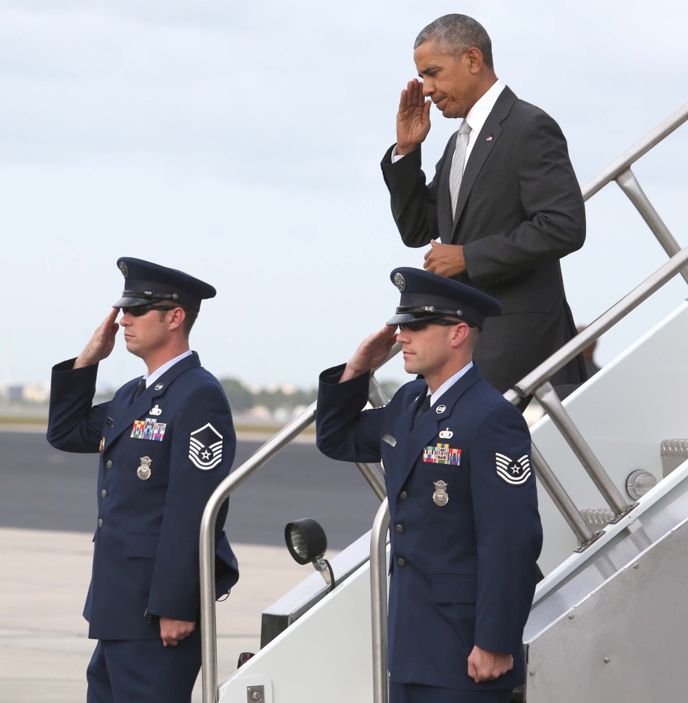 Joe Burbank/Orlando Sentinel
President Obama returns a salute Friday as he arrives at Orlando International Airport for a rally for the Hillary Clinton campaign at the University of Central Florida.