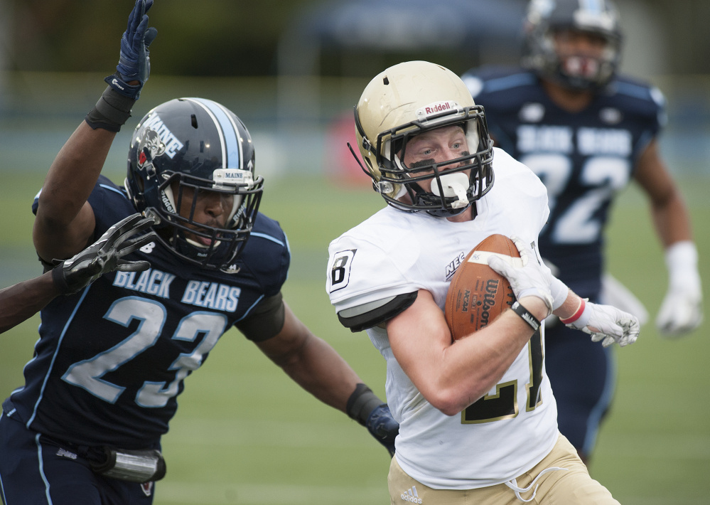 Kevin Bennett PhotoMozai Nelson of Maine tries to bring down Bryant running back Matt Sewall just before Kennan scored a touchdown in the first half Saturday at Orono. Bryant opened a 21-0 lead before Maine stormed back for the 35-31 win.