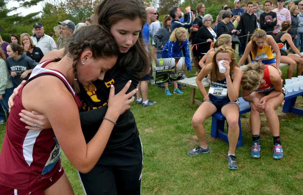 Cape Elizabeth High School's Kelsey Kennedy, far left, is comforted by a teammate following her race at the Festival of Champions on Saturday in Belfast.