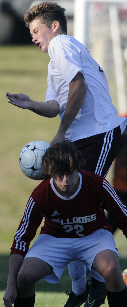 Monmouth's Corey Armstrong goes over the top of Hall-Dale's Brendan McKenzie during a soccer game Tuesday in Monmouth.