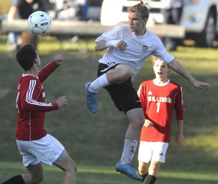 Monmouth's Shane Kenniston kicks the ball past Hall-Dale's John Whitcomb during a soccer game Tuesday in Monmouth.