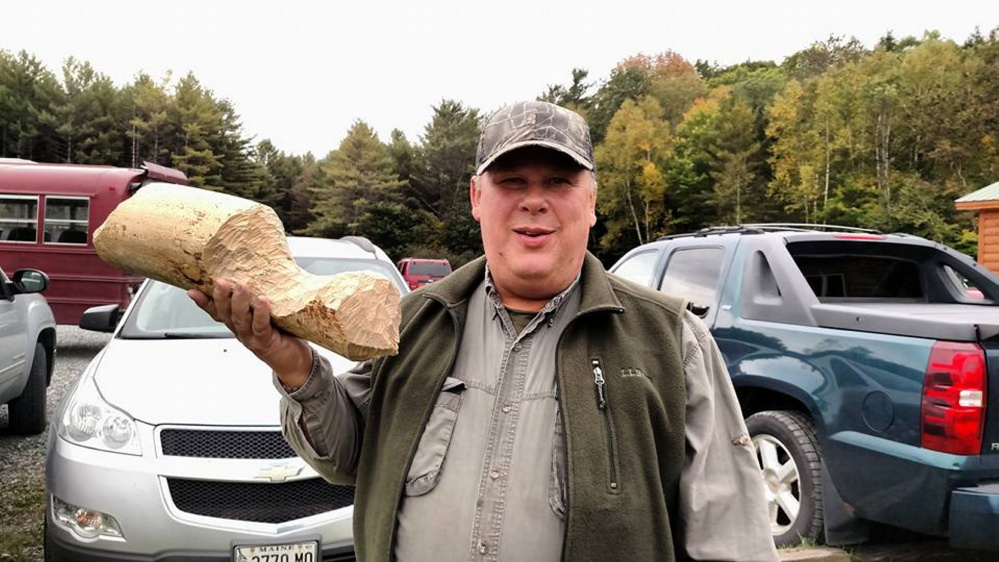 Al Duplessis, of Jackman, shows a hunk of wood gnawed by a beaver during the nature hike.