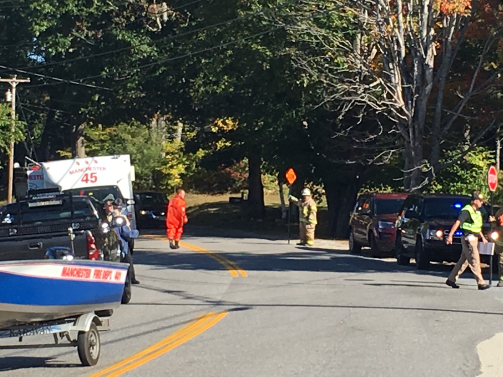 Emergency crew members direct traffic about 10:30 a.m. Thursday at the intersection of Pond and Collins roads in Manchester, near where the body of Hallowell resident Richard Barrett was found in Cobbossee Lake.