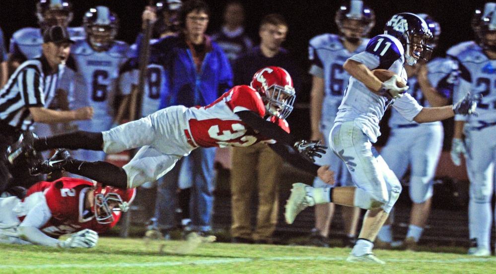 Cony's Michael Wozniak, left, dives after Hampden's Tyler Knights during a Pine Tree Conference B game Friday in Augusta.