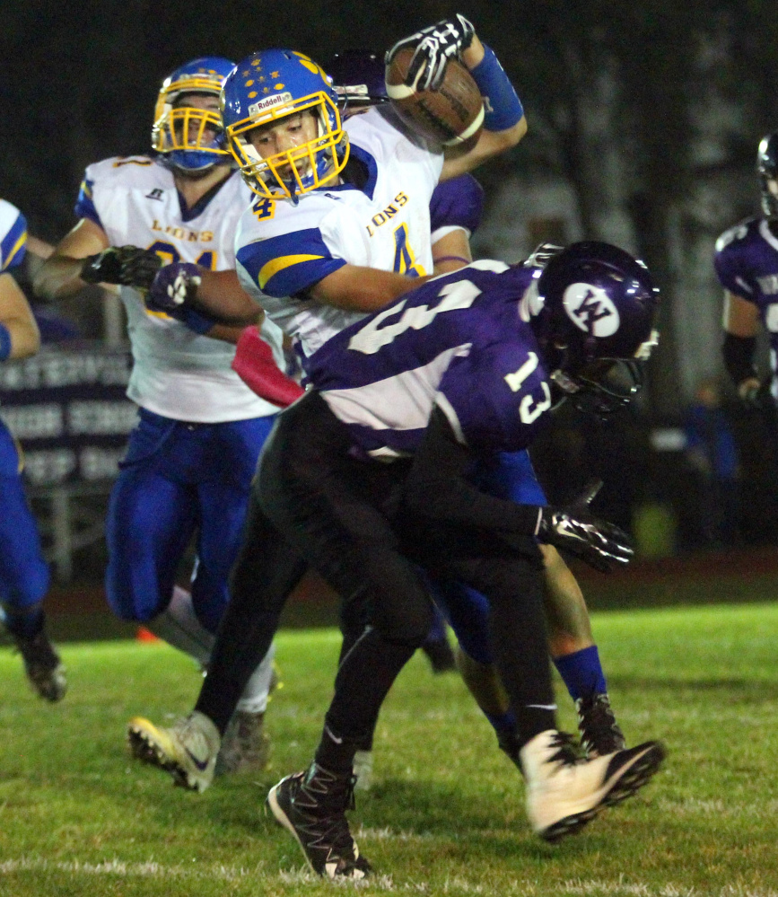 Belfast's Stan Sturgis fights off would-be Waterville tackler Gabriel Bohner during first-half action Friday night in Waterville.