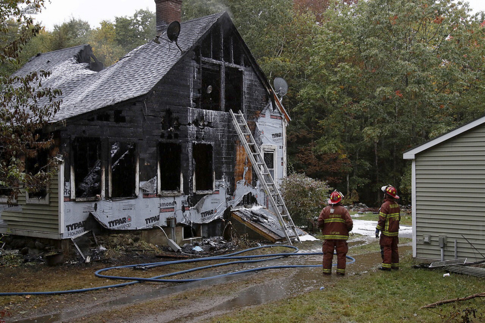 Firefighters battle a fire Sunday at 116 Pleasant Cove Road in Boothbay. Two people died and four others were injured. Joel Page/Staff Photographer