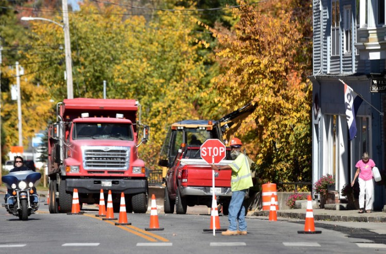 Construction crews work on the sidewalks on Main Street in downtown Wilton on Friday.