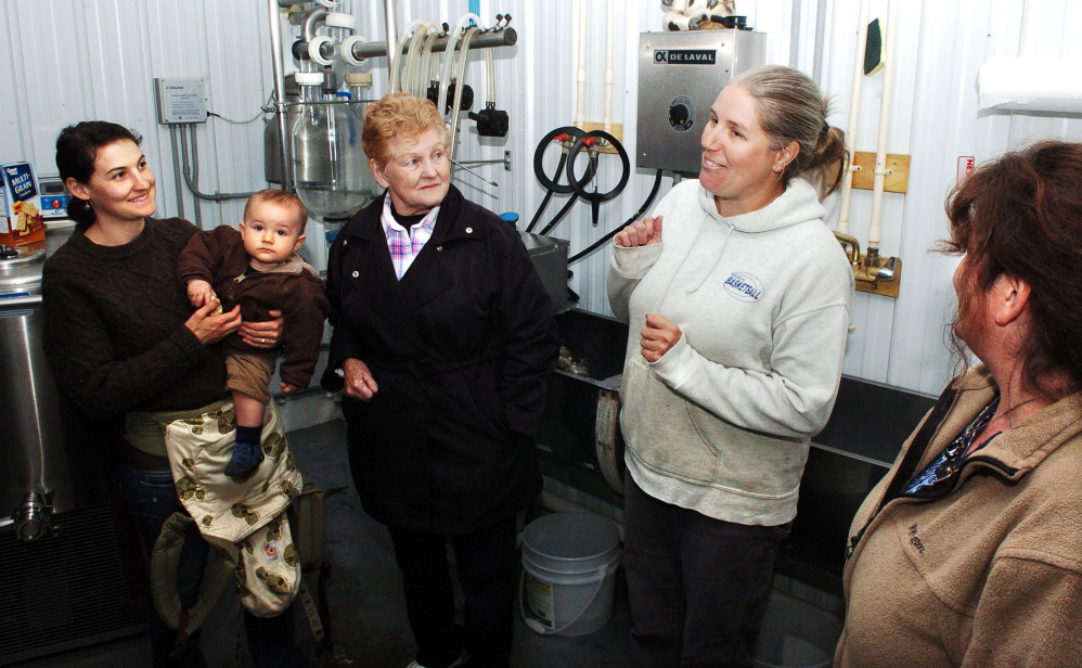 Heather Donahue, second from right, explains the process of making cheeses in the creamery section of a barn at the Balfour Farm in Pittsfield during Open Creamery Day on Sunday.