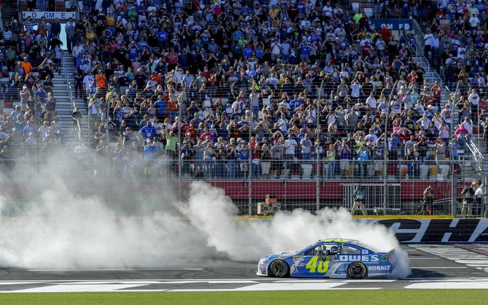 Jimmie Johnson celebrates after winning a NASCAR Sprint Cup Series race Sunday at Charlotte Motor Speedway in Concord, North Carolina.