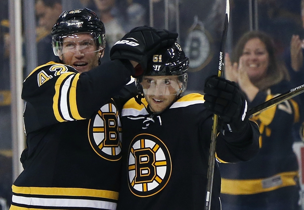 Boston Bruins forward Ryan Spooner (51) celebrates his winning goal with teammate David Backes during overtime of a preseason game against the Flyers in Boston on Saturday.