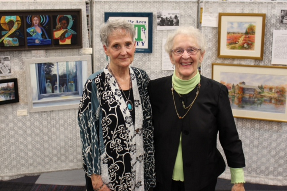 Patricia Binette, left, and Pauline Turner stand in front of a display of their work at an opening reception honoring them at the 30th anniversary of the Waterville Area Art Society they co-founded with Marilyn Dwelley and Peggy Stowers.