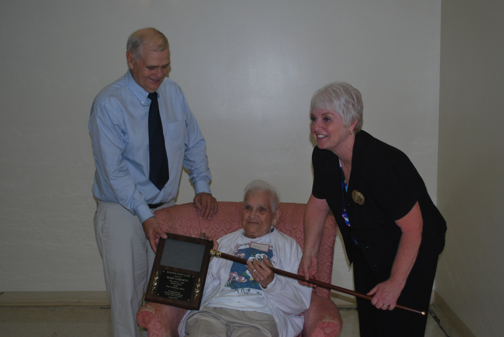 The Boston Post Cane recently was presented to Mary Garnett, center, by Pam Violette, town manager of Clinton. Garnett also received a plaque from Clinton Historical Society President Blair "Buddy" Frost. At age 93, Garnett is the oldest resident of Clinton.