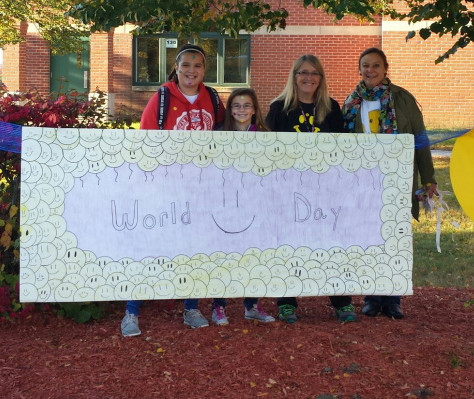 Vassalboro Community School recently celebrated World Smile Day. From left are Kassidy Hopper, Emma Cherest, Diana Gram, principal; and Sue Briggs, art teacher.