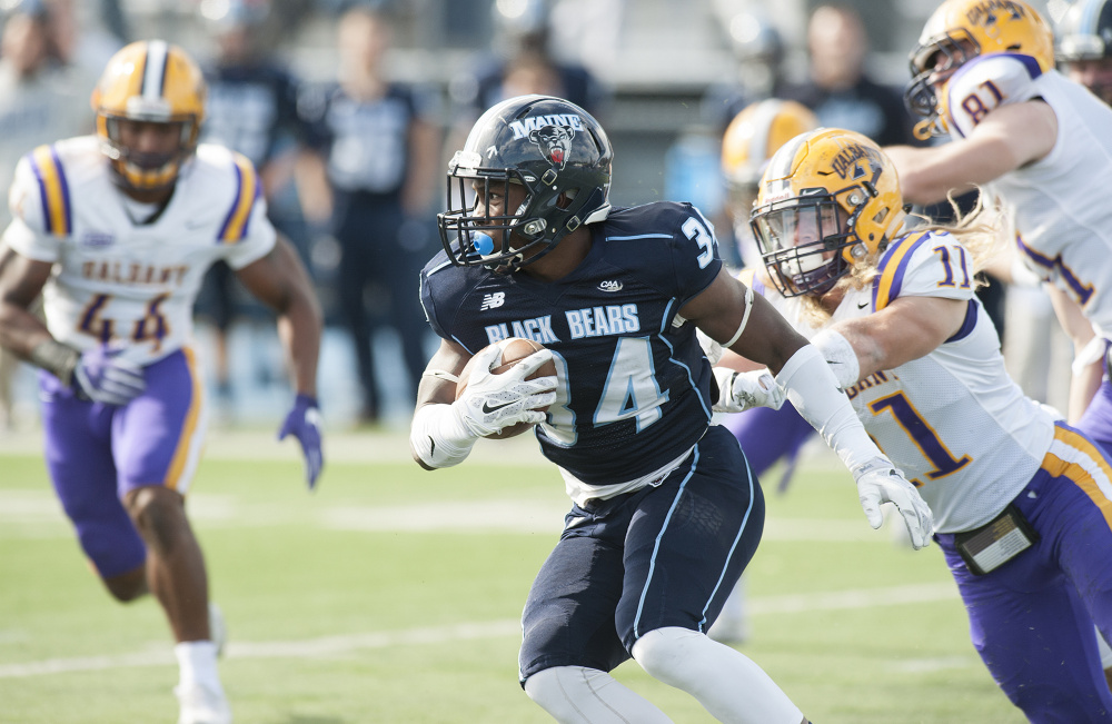UMaine's  Josh Mack gains yardage against Albany during the first half Saturday in Orono. Photo by Kevin Bennett
