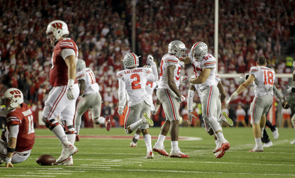 Ohio State players celebrate after defeating Wisconsin 30-23 in overtime Saturday in Madison, Wisconsin.