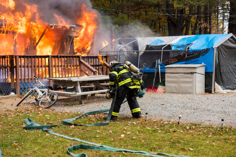 Farmington firefighters battle a mobile home blaze Tuesday morning on Whittier Road.
