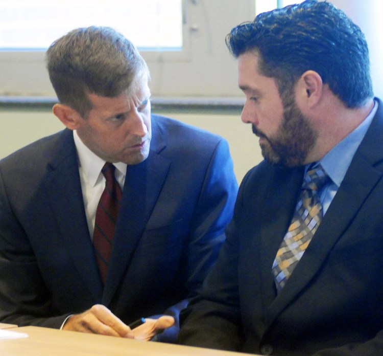 Bryan Carrier, right, and his attorney, Walt McKee, confer during a hearing Sept. 26 in Augusta at the Bureau of Motor Vehicles, where Carrier asked to have his drivers license restored.