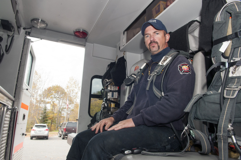 The Pittston Fire Department's newly acquired used heavy response truck, which features room for four people to sit in back seat wearing air tanks and seat belts, stands in front of the town's main station on Route 126.