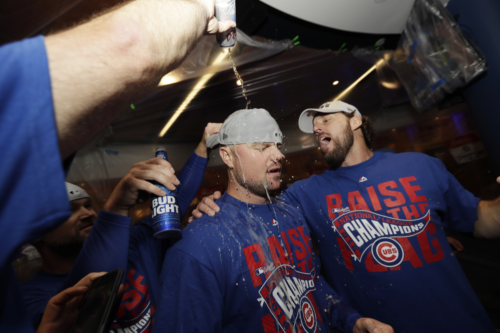 Chicago Cubs' pitchers Jon Lester, left, and John Lackey celebrate after Game 6 of the National League Championship Series against the Los Angeles Dodgers on Saturday in Chicago. The Cubs won 5-0 to win the series and advance to the World Series against the Cleveland Indians.