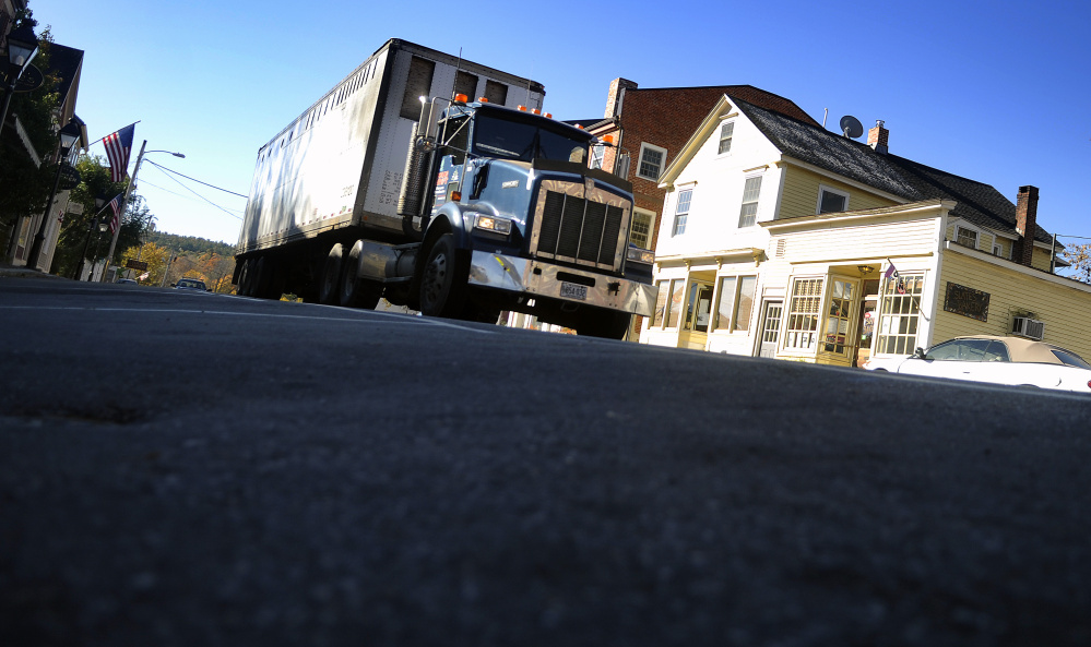 In this October 2015 file photo, a truck drives on Water Street in Hallowell where the Maine Department of Transportation plans to reduce the crown on the road and perform other work during a major reconstruction project set for 2018.
