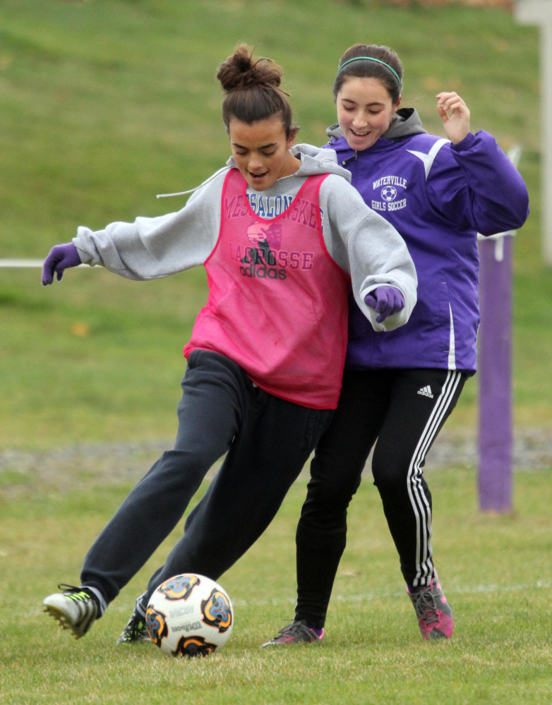 Waterville Senior High School's Jordan Jabar tries to keep the ball from Lily Foster during practice on Monday.